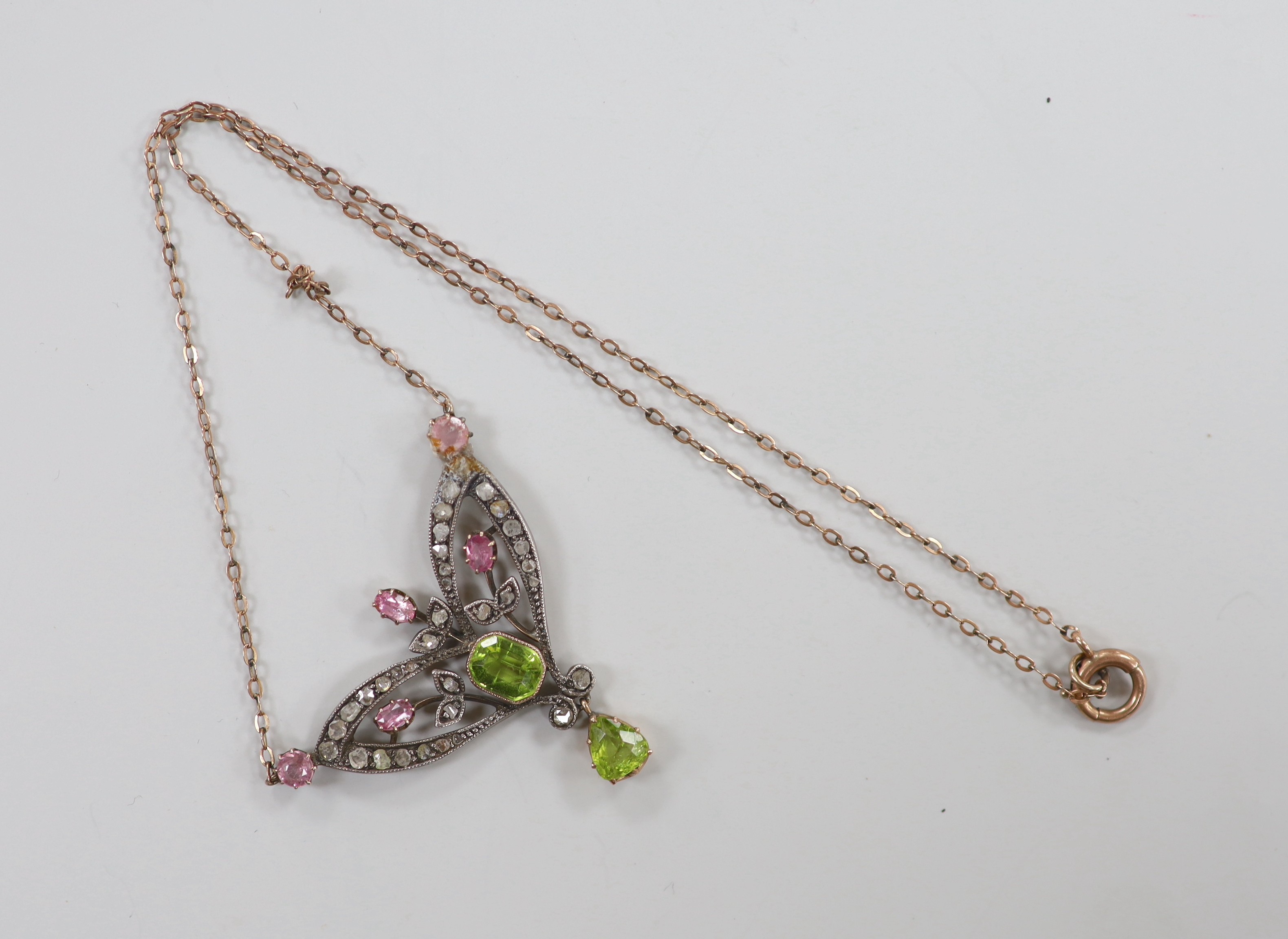 A late Victorian 9ct and white metal. peridot, pink topaz? and rose cut diamond set pendant necklace (a.f.), pendant width 44mm, chain length approx. 34cm, gross weight 7.2 grams.
